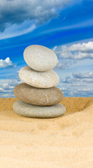 Fototapeta na wymiar Image of stones in the sand against the sky closeup