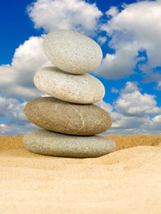 Fototapeta na wymiar stones in the sand against the sky close-up