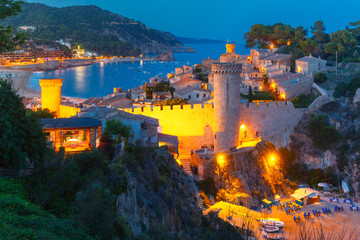 Aerial view of Fortress Vila Vella and Badia de Tossa bay at night in Tossa de Mar on Costa Brava, Catalunya, Spain