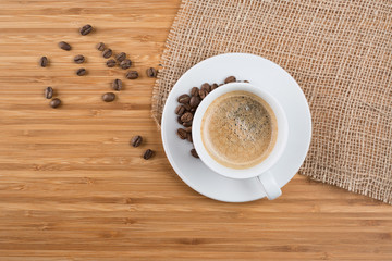 Fresh coffee beans on wood and linen
