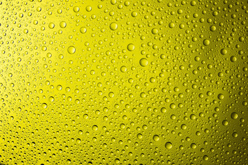 Water drop on yellow background.
