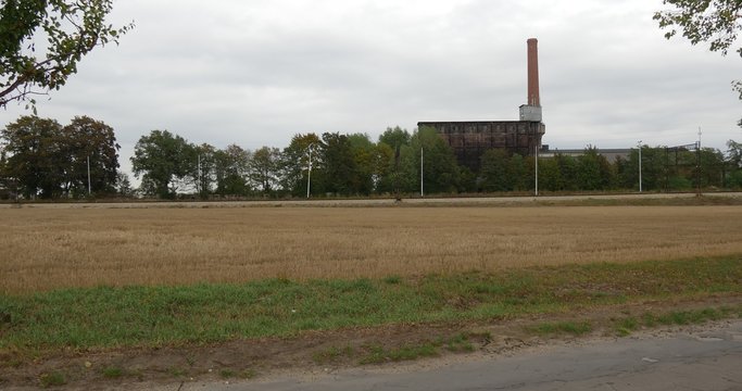 Ecology Environment Pollution Asphalted Road to Electric Station Wires Cement Factory on a Horizon at The Field Green Trees Tubes Electric Towers