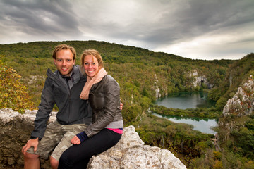 Young happy couple at a panoramic point in Plitvice national park, an UNESCO world heritage site, in Croatia