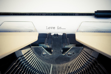 typewriter with white paper. Love is sign