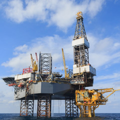Fototapeta na wymiar Offshore Jack Up Drilling Rig Over The Production Platform 