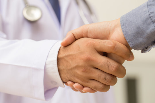 Doctor shakes hands with a patient