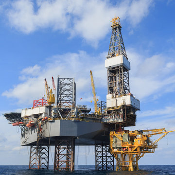 Offshore Jack Up Drilling Rig Over The Production Platform 