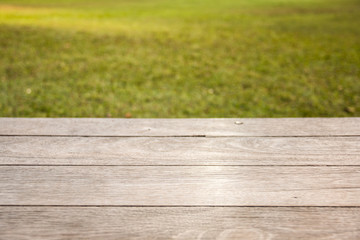 Empty wooden table on garden background. Ready for product display montage.