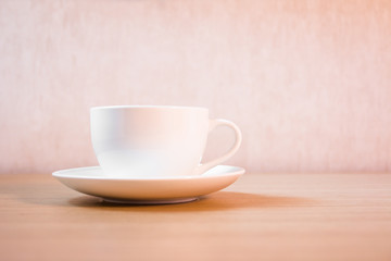 A cup of coffee on wooden background