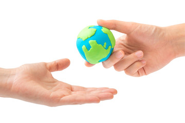 Human hand sending the earth into another hand isolated on white background. environment, Creation, Genesis, God and Adam, Responsibility, Mission concept.