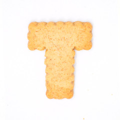 letter T made of cracker cookie isolated on white background.