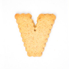 letter V made of cracker cookie isolated on white background.