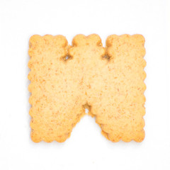 letter W made of cracker cookie isolated on white background.