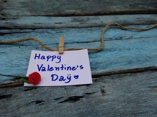 Happy valentines day note on wood background