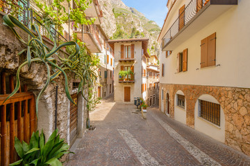 Narrow street of old apartment buildings in Malcesine, Italy.