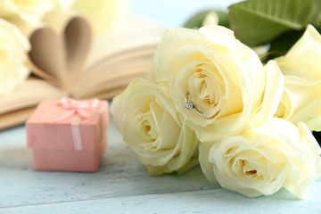Bouquet of white roses on blue wooden background
