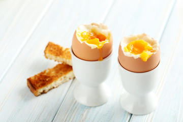 Boiled egg with toasts on a blue wooden table