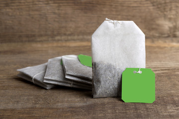 Teabags on wooden background