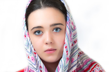 Closeup portrait of beautiful young girl covered with a headscarf.