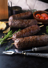 Grilled minced meat on a skewer with garlic, rosemary and spices
