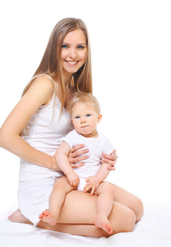 Happy smiling mother and baby sitting on white background