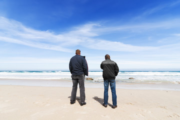 men in the beach watching the atlantic sea  in Razo, Spain