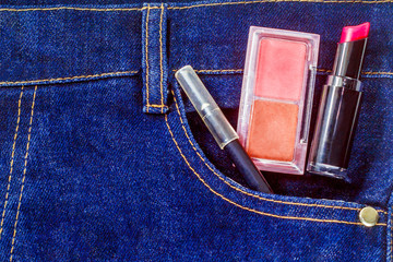 closeup photos of makeup items in a jeans pocket