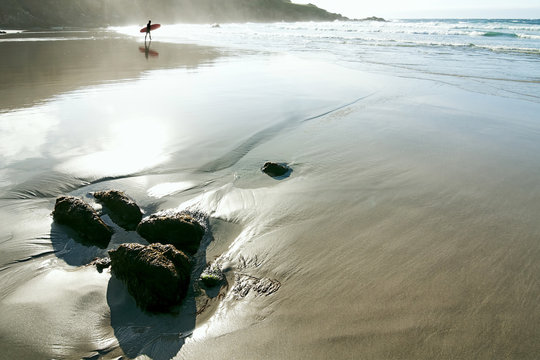 surfer  in the beach of the Atlantic Ocean with blue sky , Caion