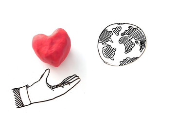 Love the world concept , draw of heart in hand reach to the world 