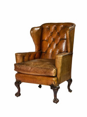 antique leather wing chair carved legs isolated with clip path