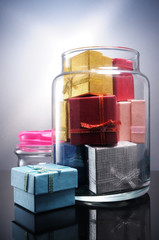 Bunch of gift boxes filling a glass flask