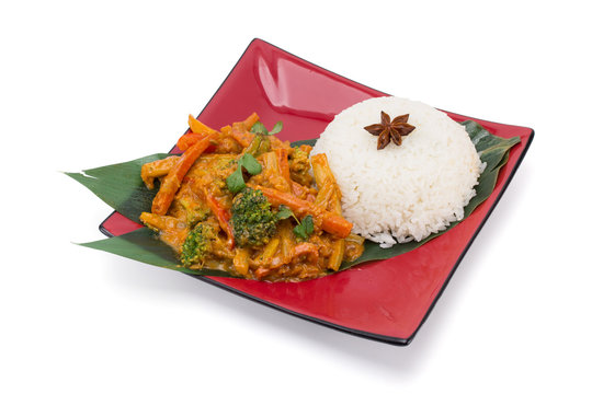 Rice with vegetables in sauce isolated on white background