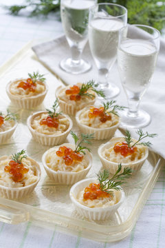 Tartlets with cream cheese and red caviar close up. Snacks with red caviar with aperitif. Light background.