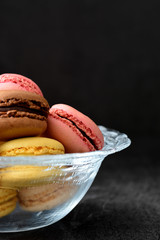 Macarons in a bowl. Black background
