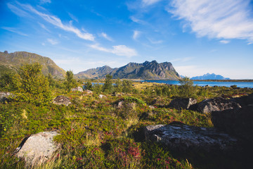Classic norwegian scandinavian summer landscape with mountains, fjord, lake and a church, with a blue sky, Norway, Lofoten Islands