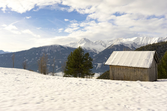 Wooden hut in mountain snow
