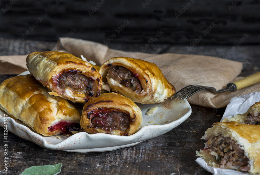 Wall mural Homemade pork sausage rolls with chestnuts, cranberry sauce and sage