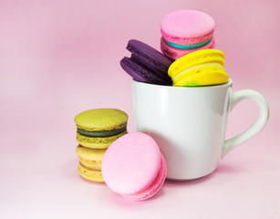 macaron in cup on pink background