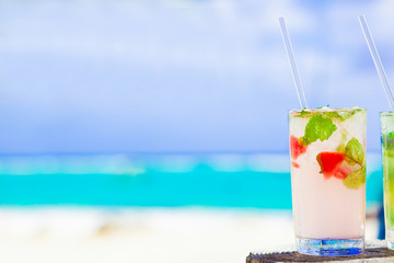 two exotic mojito cocktails near white sand beach