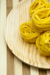 Italian noodle nest on wooden