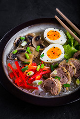 Noodles with egg and duck meat in bowl