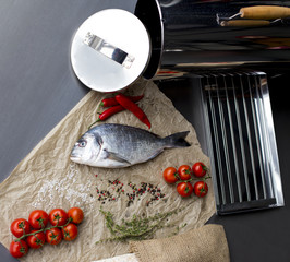 Food background with fresh fish on dark board. Fish with  spices and vegetables. healthy food, diet or cooking concept