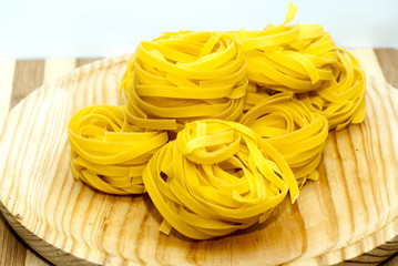 Italian noodle nest on wooden