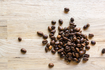 roasted coffee grain on a raw oak table