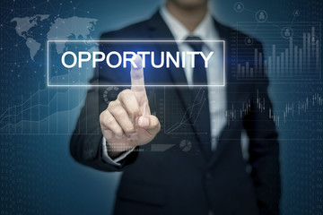 Businessman hand touching OPPORTUNITY button on virtual screen