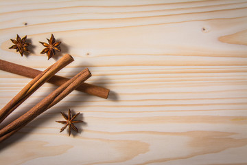 cinnamon sticks and anise stars on wooden table