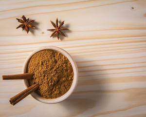 cinnamon in wooden bowl and anise stars