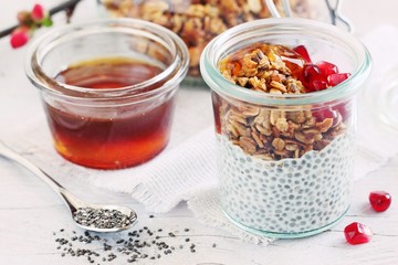 Superfoods concept : overnight chia pudding with homemade granola,pomegranate and honey. Healthy eating. Selective focus. 
