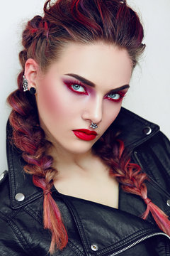 Girl with makeup in a rock style. Piercing.