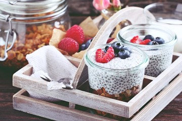 Superfoods concept : overnight chia pudding with homemade granola,fresh berries and honey. Healthy...